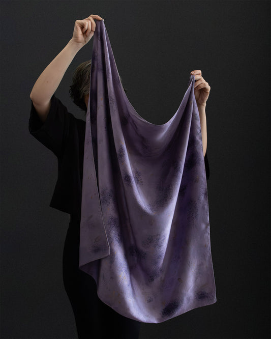 Hand holding a naturally dyed silk scarf