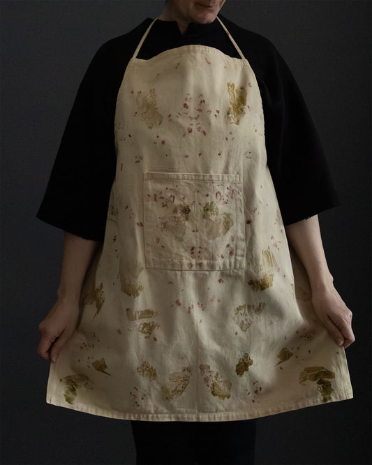 naturally dyed apron with plant prints, worn