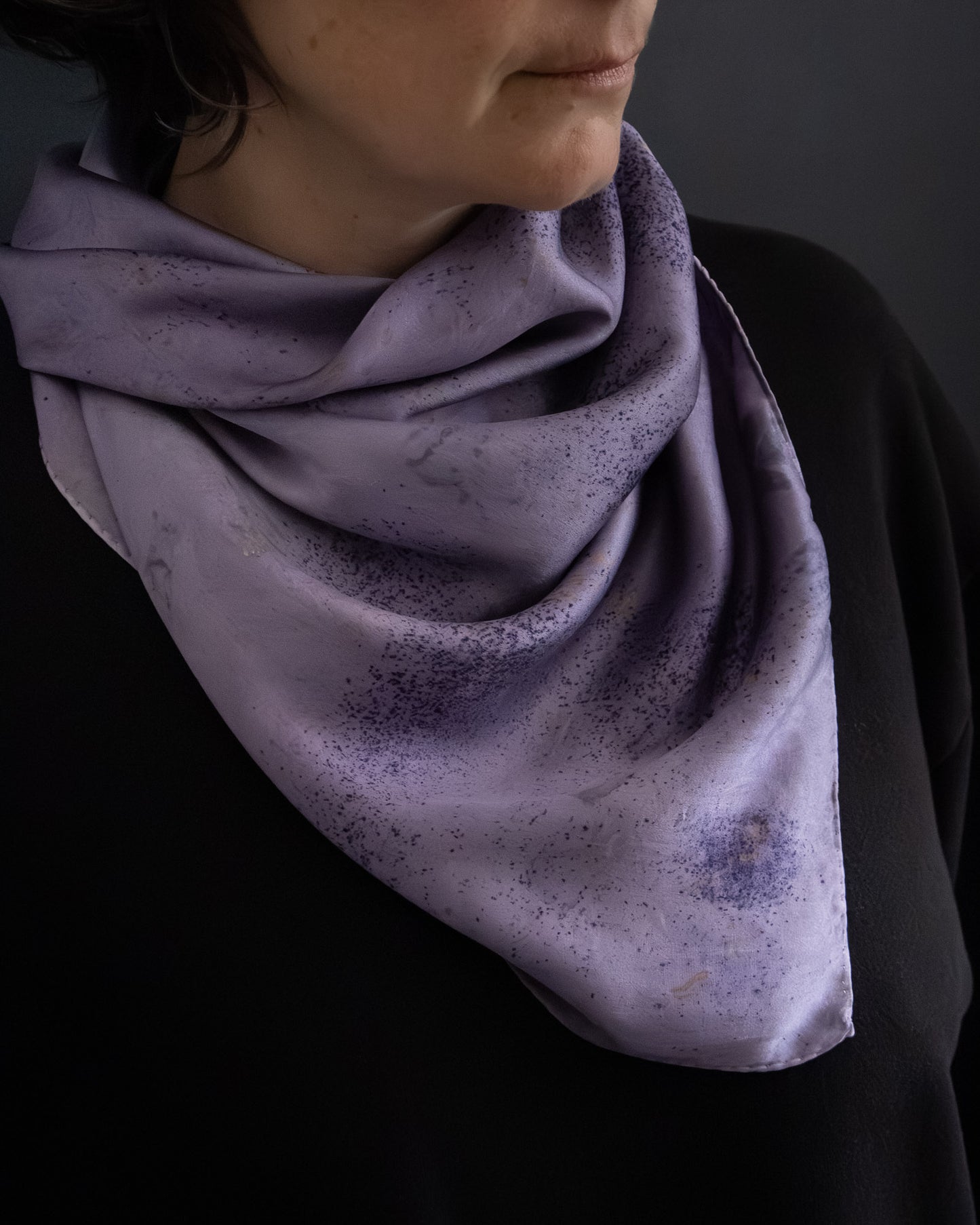 Naturally dyed silk scarf worn around the neck