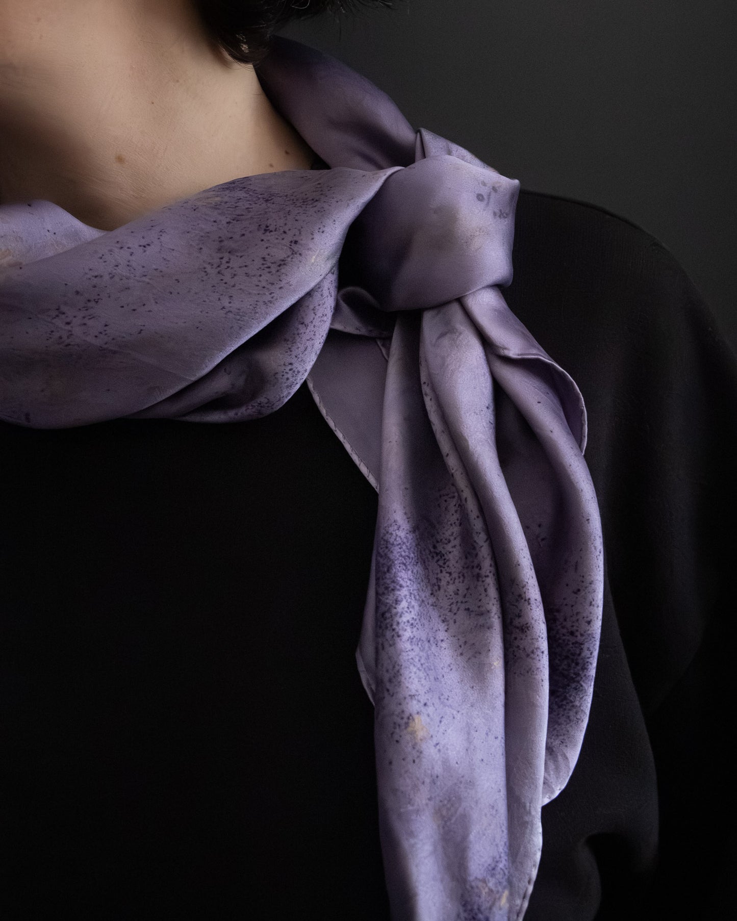 Naturally dyed silk scarf styled around the neck