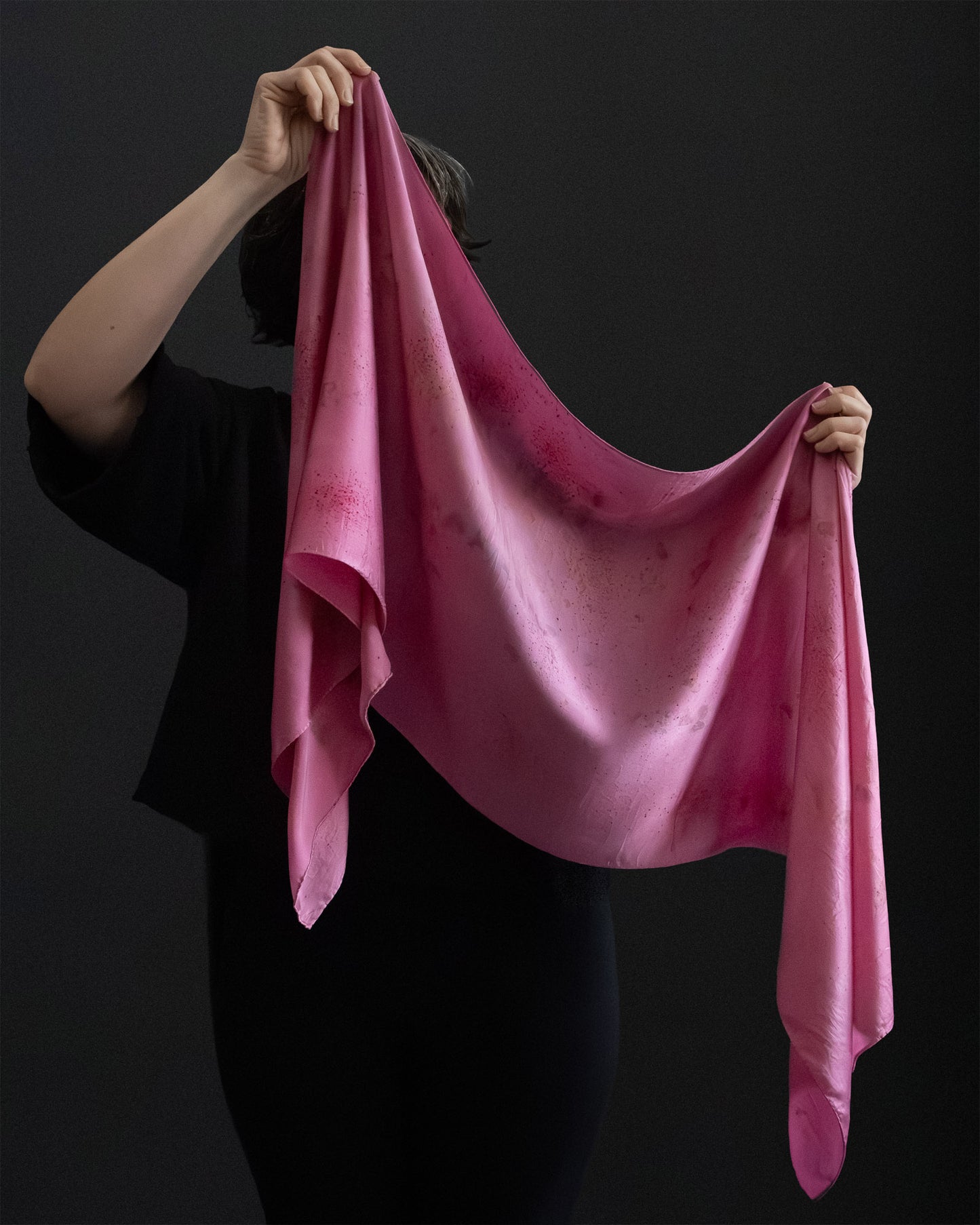 naturally dyed silk scarf held open in hands, cochineal dye