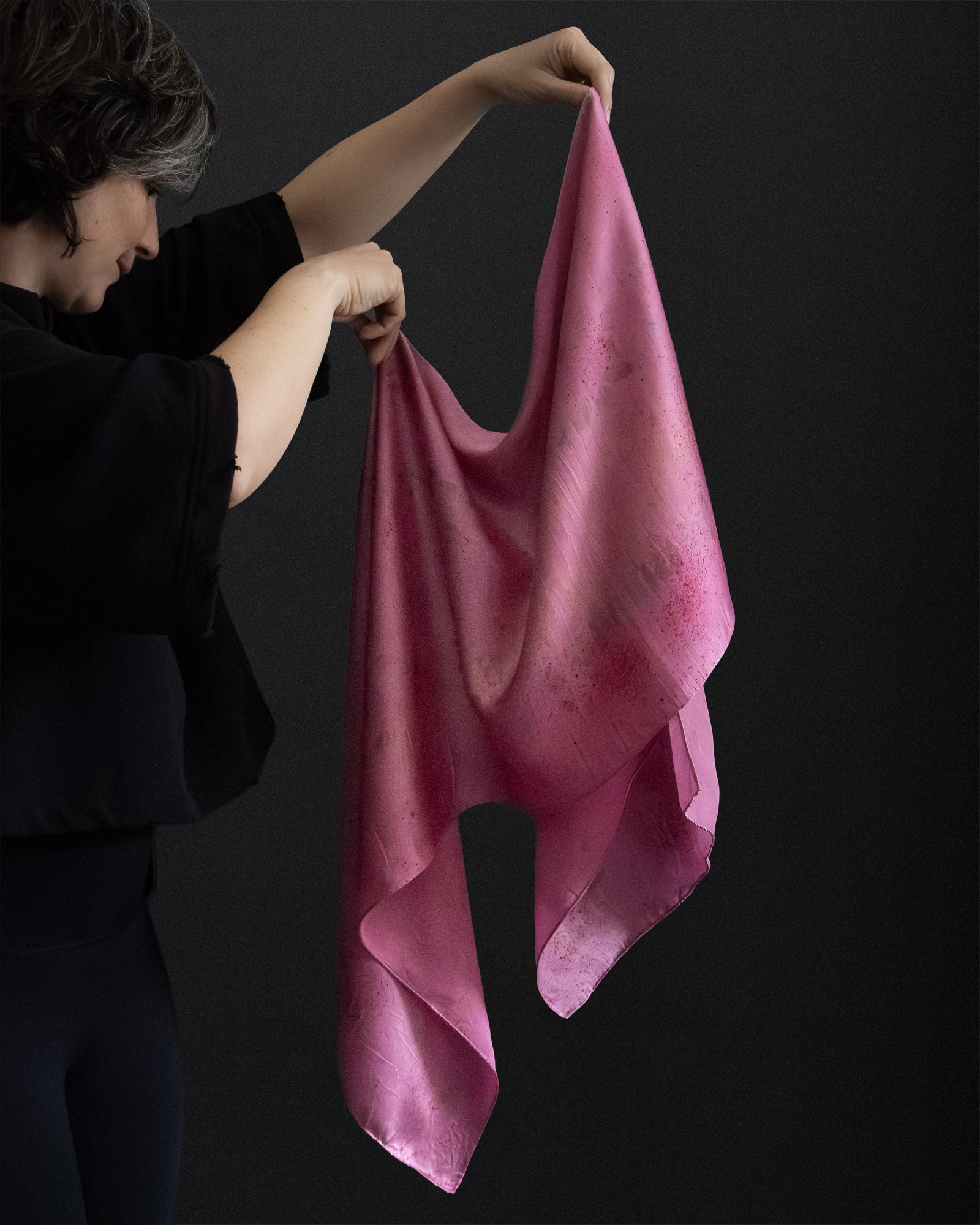 silk scarf naturally dyed, held and shown in movement