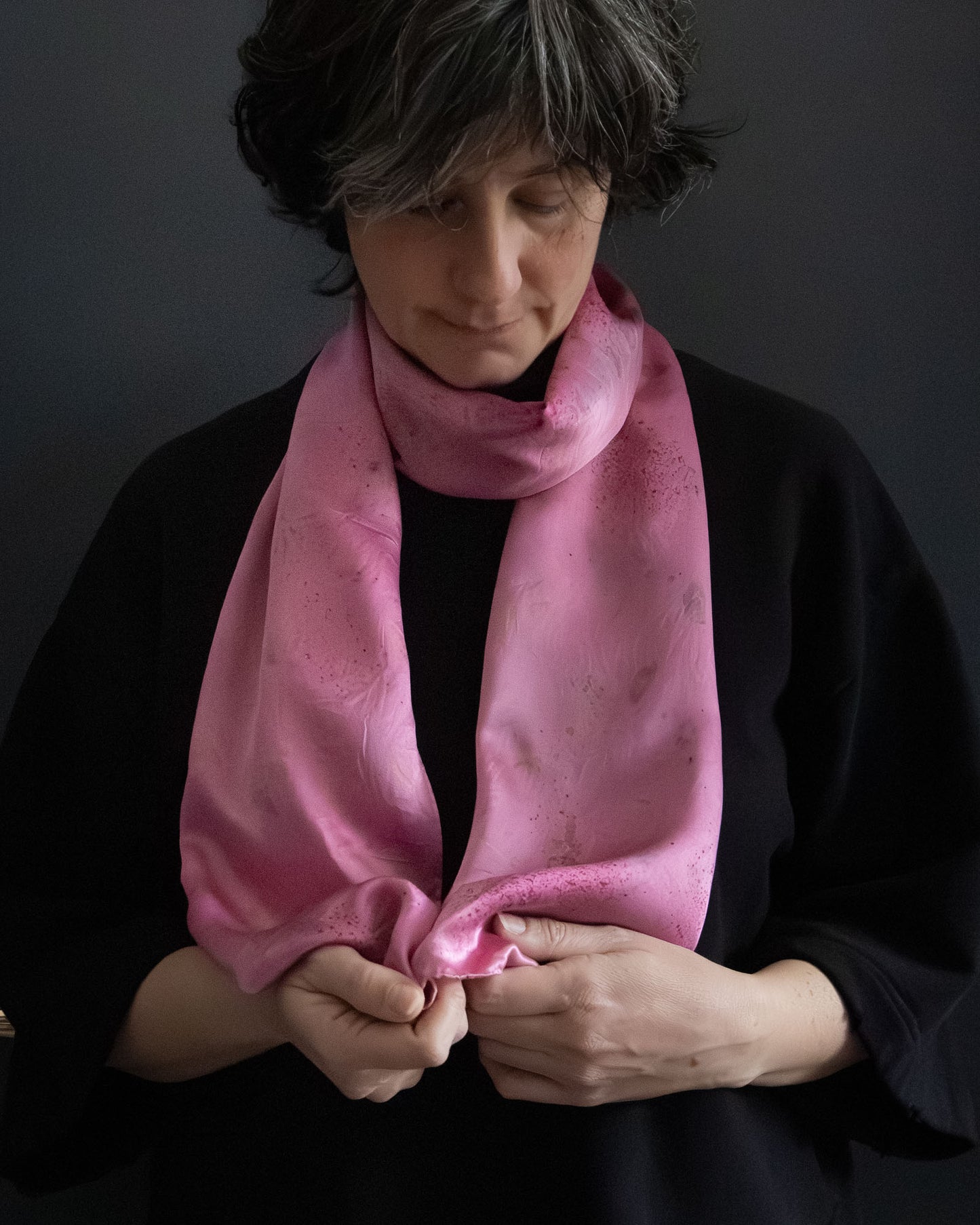 silk scarf in pink tones, naturally dyed with cochineal, worn close-up