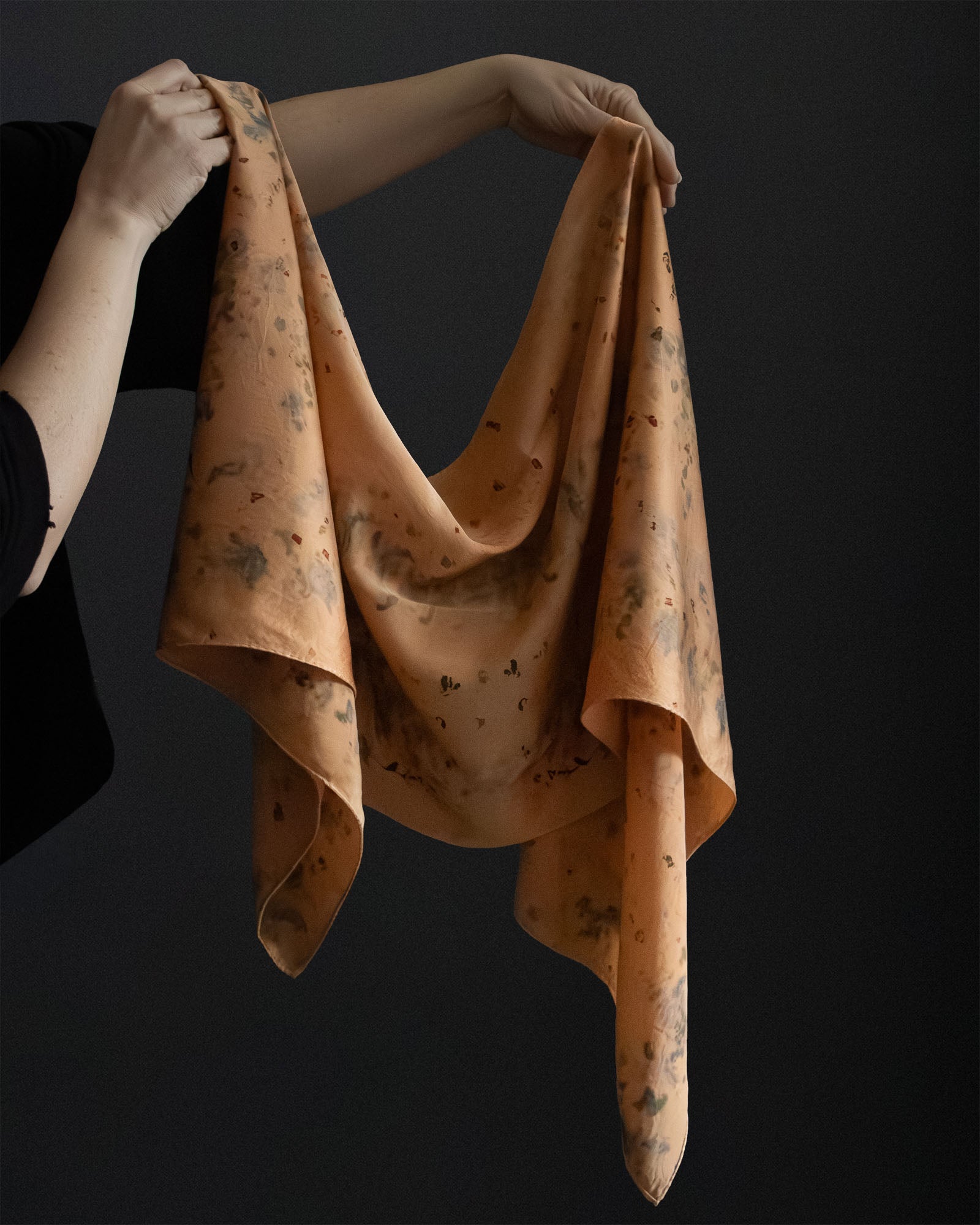 naturally dyed silk scarf held open in hands, madder root dye