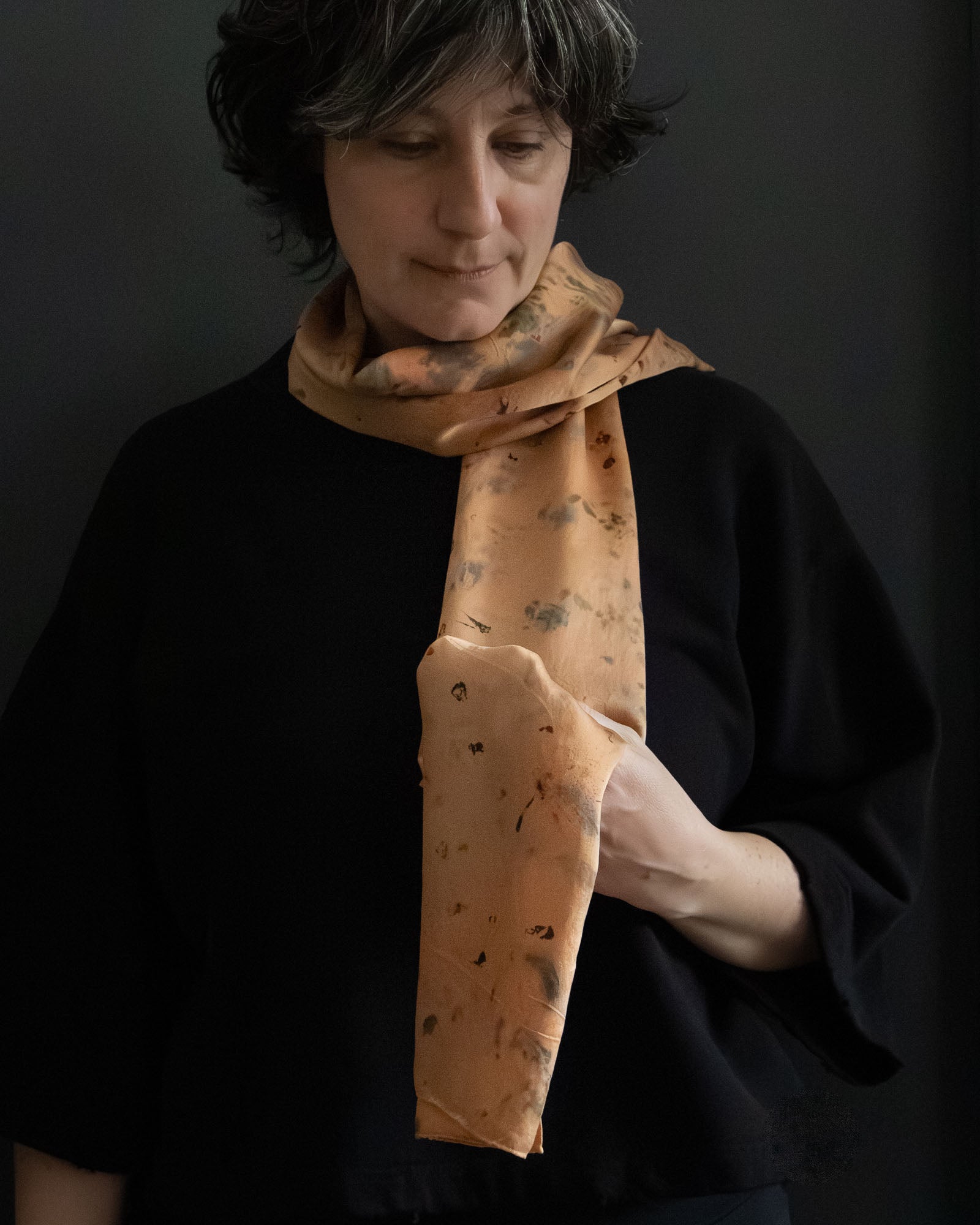 naturally dyed silk scarf in madder root tones, worn around the neck