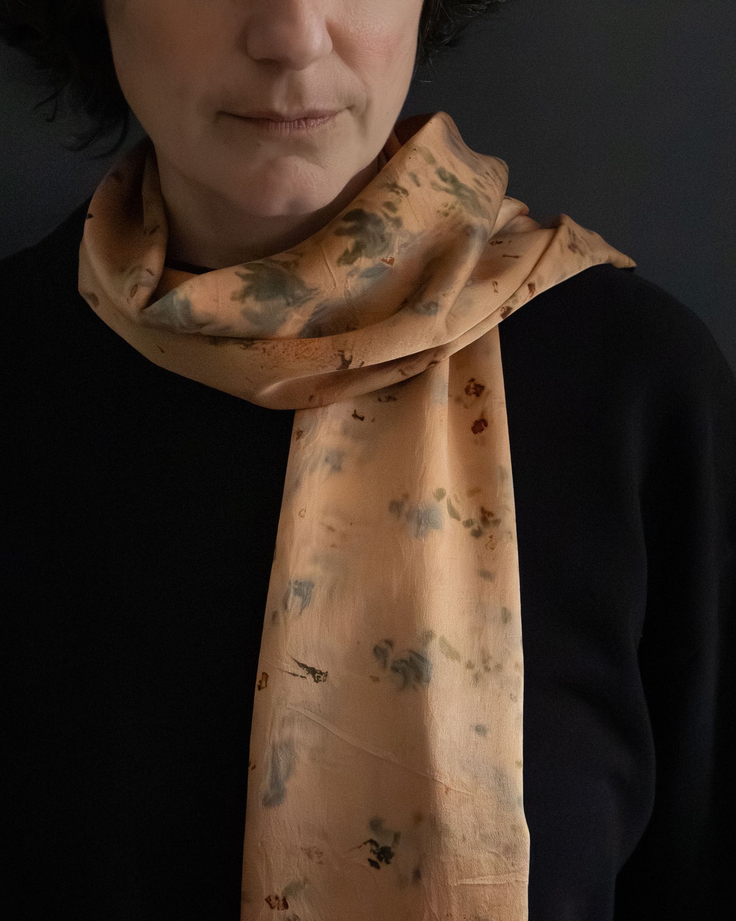 silk scarf in warm orange tones, naturally dyed, worn front view