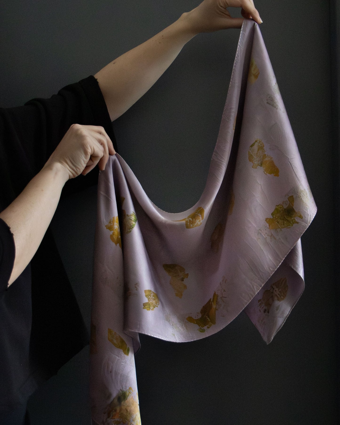 naturally dyed silk scarf with botanical prints, held open
