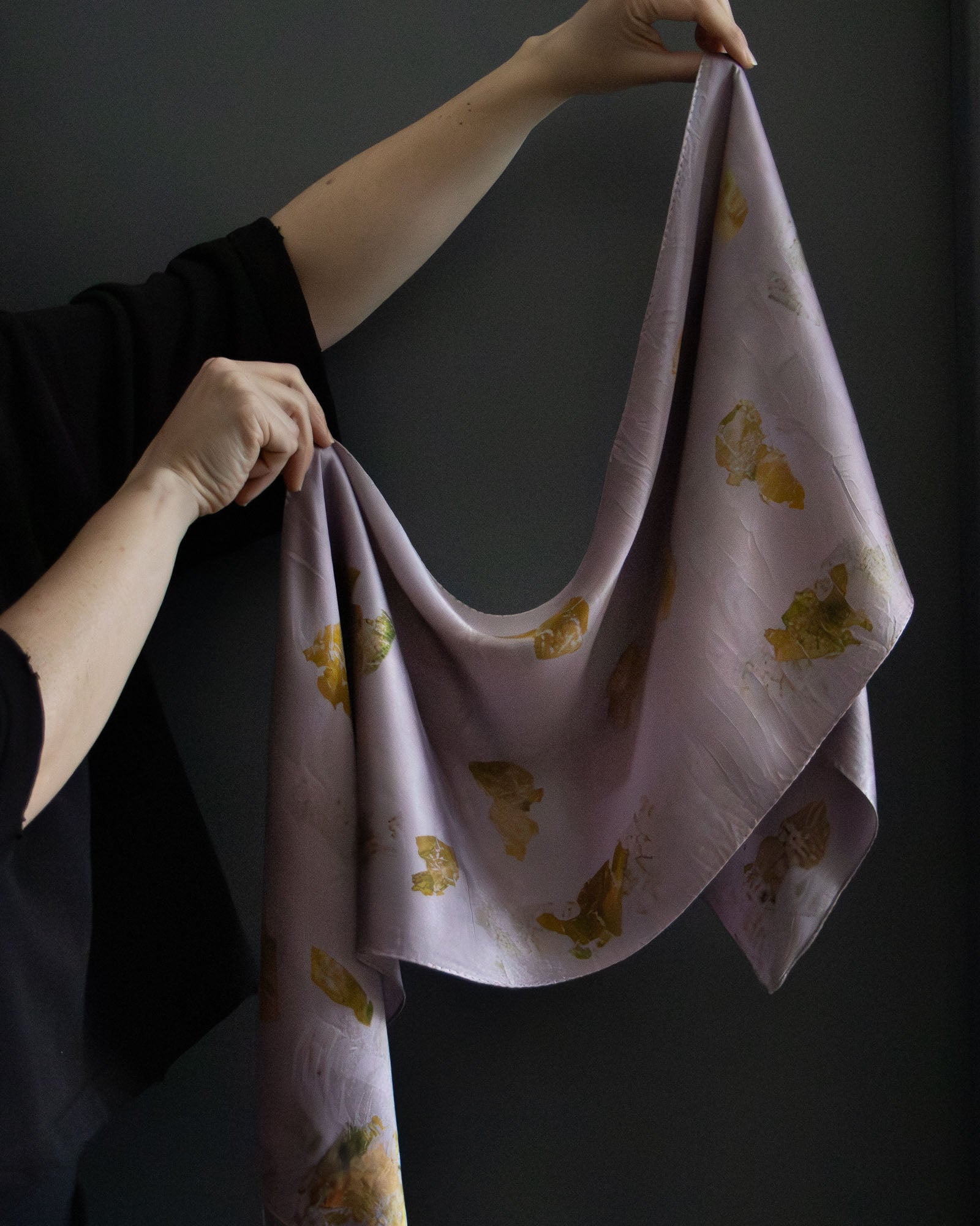 naturally dyed silk scarf with botanical prints, held open
