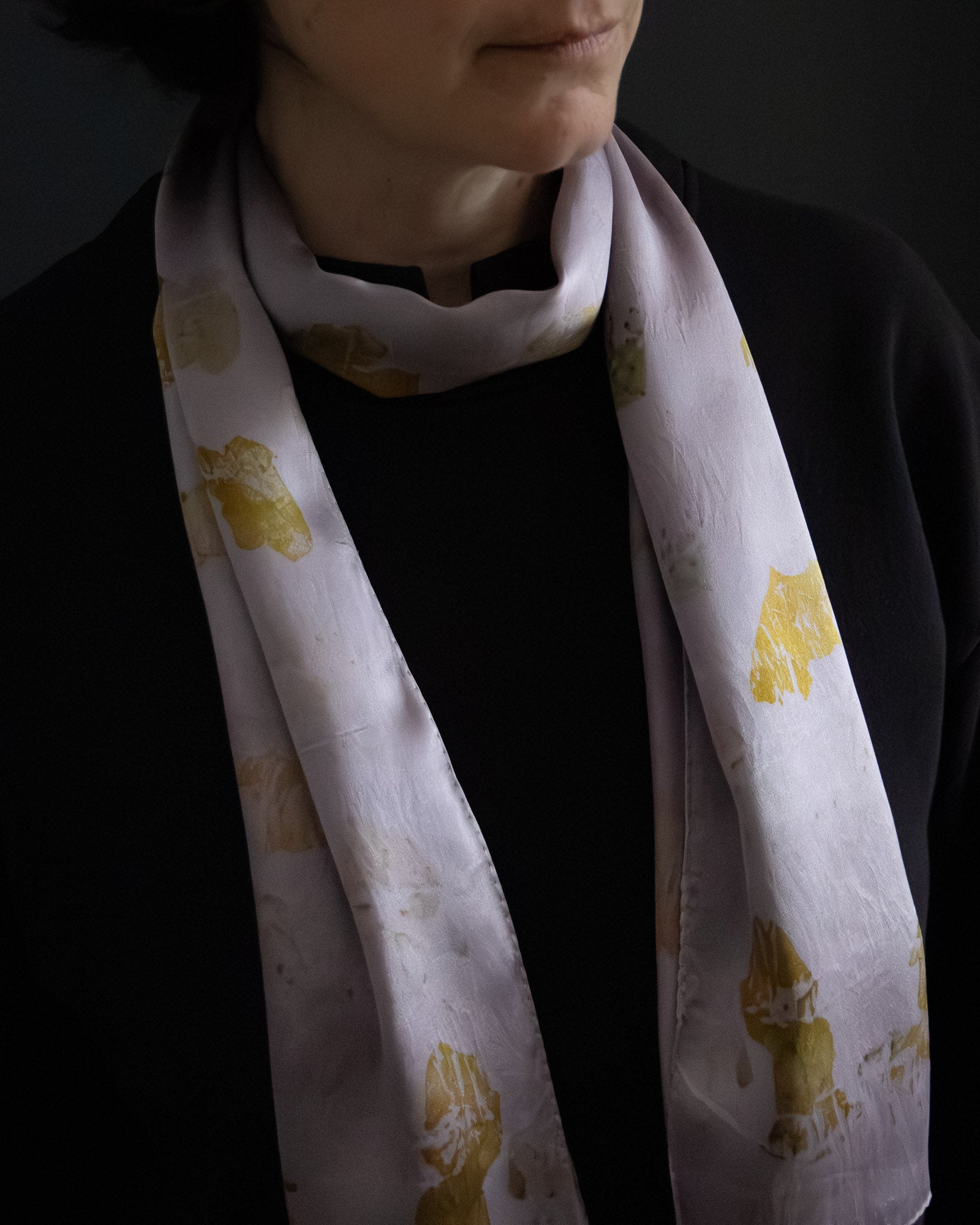 naturally dyed silk scarf with botanical prints, worn