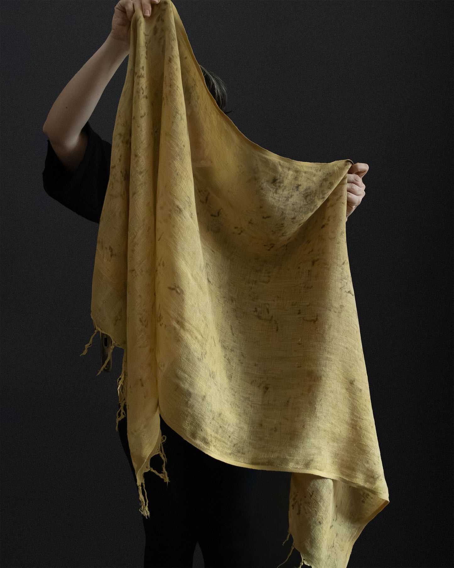 hands holding a naturally dyed linen scarf