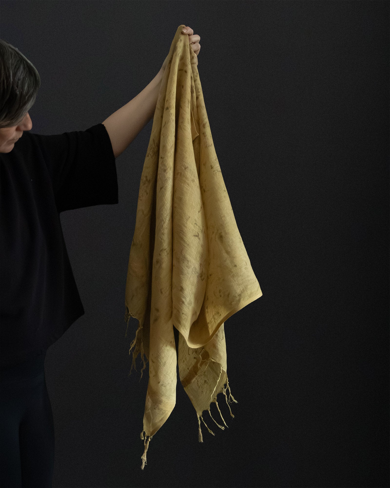Hand holding an one of a kind linen scarf