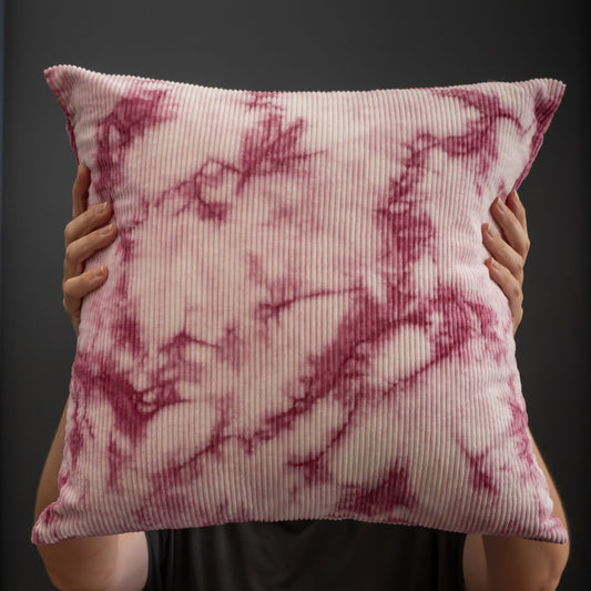 Front view of a naturally dyed corduroy cushion cover with fuchsia pink cochineal tie-dye pattern.