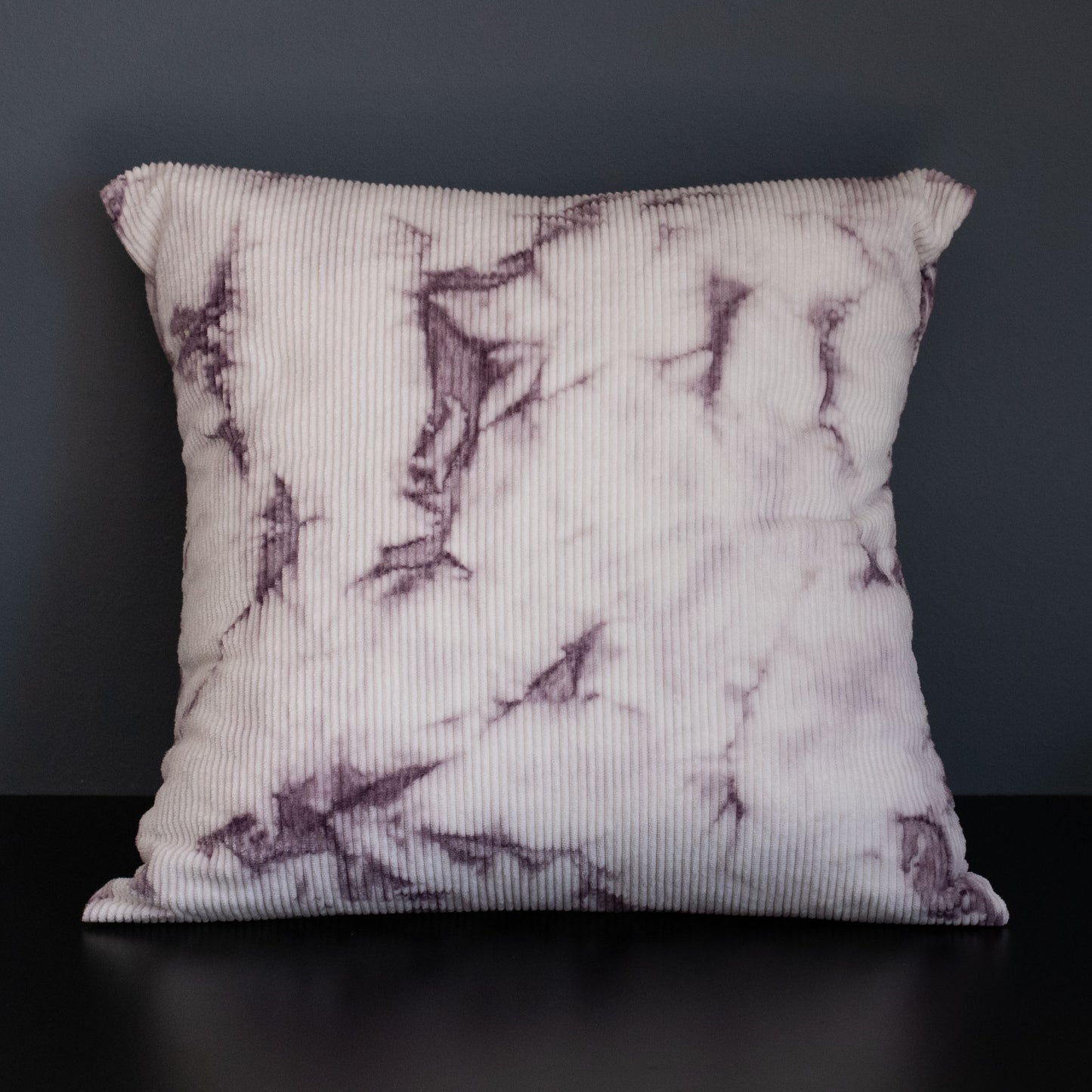 Full view of handcrafted corduroy cushion cover dyed naturally with logwood in purple and white.