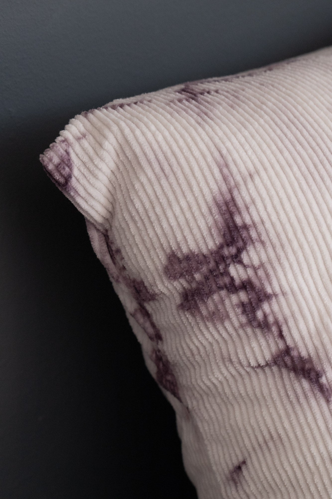 Detail of naturally dyed corduroy cushion cover with logwood tie-dye patterns.