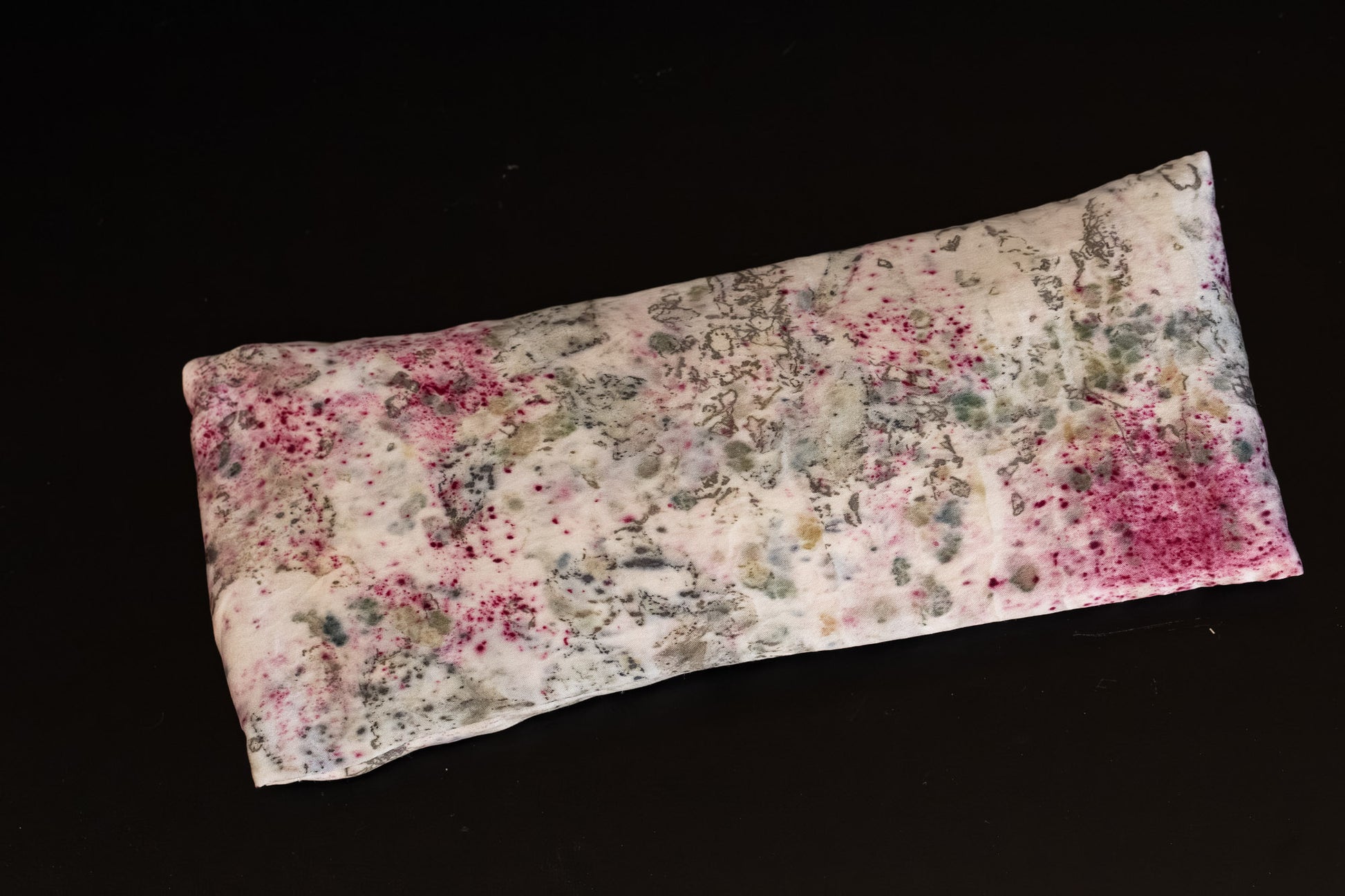 Naturally dyed silk eye pillow displayed flat to show the full pattern.